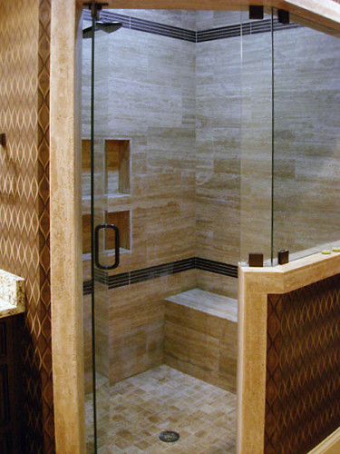 Masculine stone shower with horizontal lines and bench