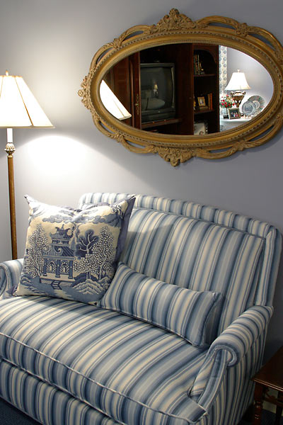 Sit for a moment in the bedroom on this cozy blue and white striped loveseat