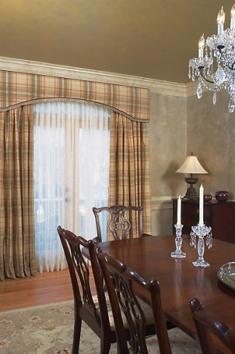 Elegant drapery and sheer curtains in a formal dining room