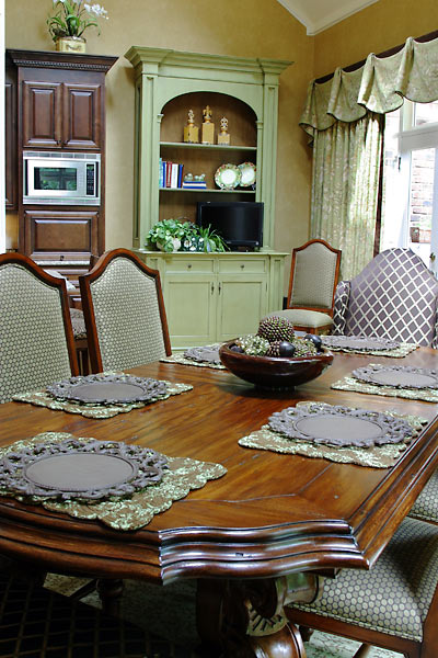 Breakfast Room with Custom Draperies and Custom-built Cabinetry for Television and Storage.