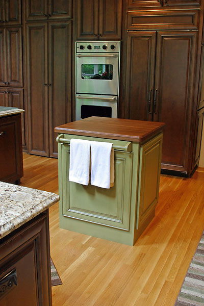 a kitchen island with towel rack