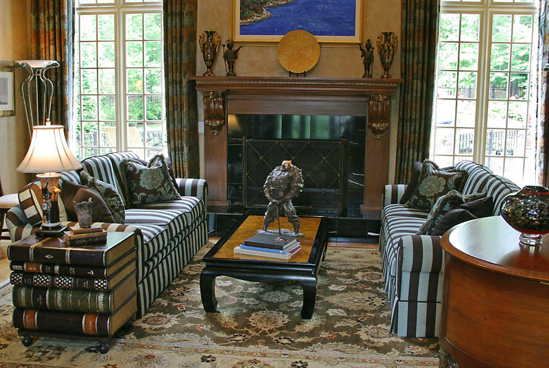 Faux wood mantle and cozy seating in this two-story living room