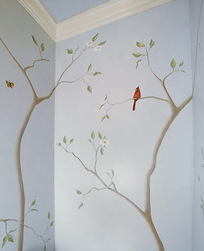 A cardinal sits on a tree branch in the powder room