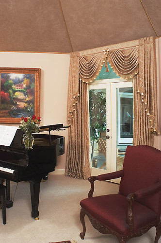 Custom window treatments over French doors in the music room