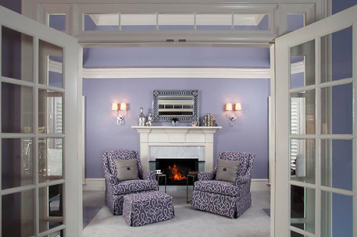 Comfortable chairs flank and elegant fireplace