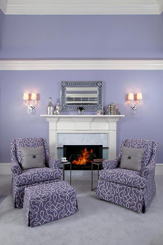 Comfortable chairs flank and elegant fireplace